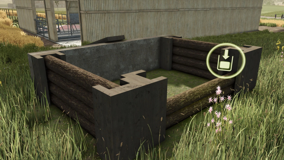 In Farming Simulator 25, a small manure heap under construction with logs, concrete walls, and an unload icon indicating placement for mods.