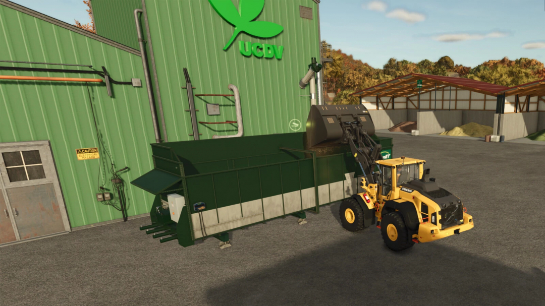 Farming Simulator 25 mods, UCDV Pellet Production Factory, heavy machinery near green building, part of farm equipment setup.
