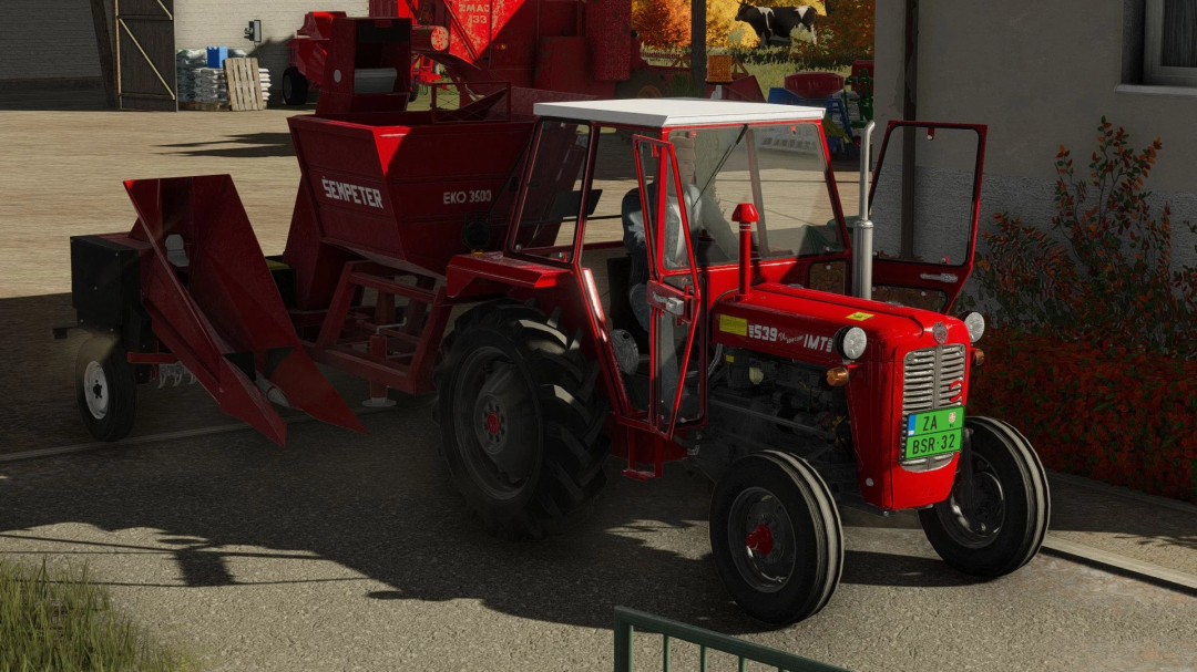Farming simulator 22 mod: red Sip Sempeter Eko 3500 tractor with attached harvesting equipment parked outside farm building.