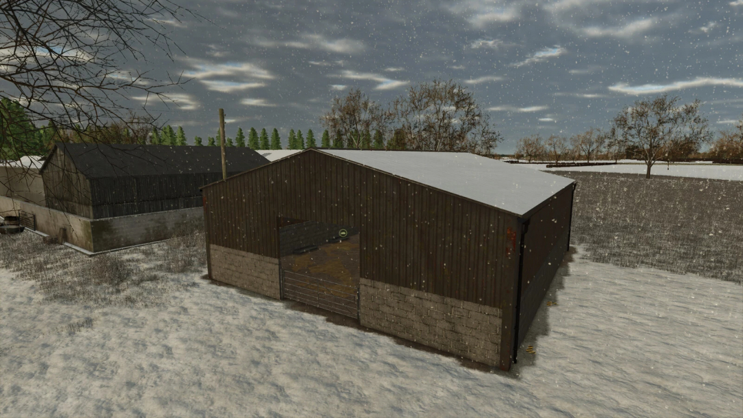 Winter scene with two farm barns, snow-covered ground, trees, and a cloudy sky in Farming Simulator 25 with the UK Indoor Sheep Barn mod.