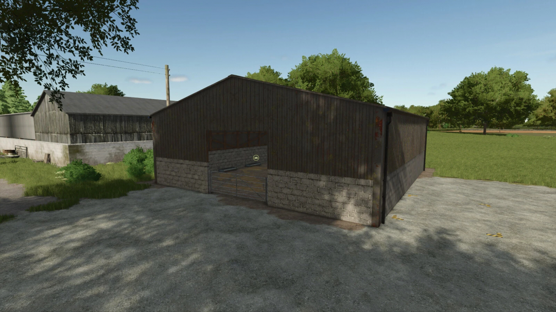 Farming Simulator 25 mod: UK Indoor Sheep Barn v1.0.0.0, a detailed metal and brick sheep housing structure in a rural farm setting.