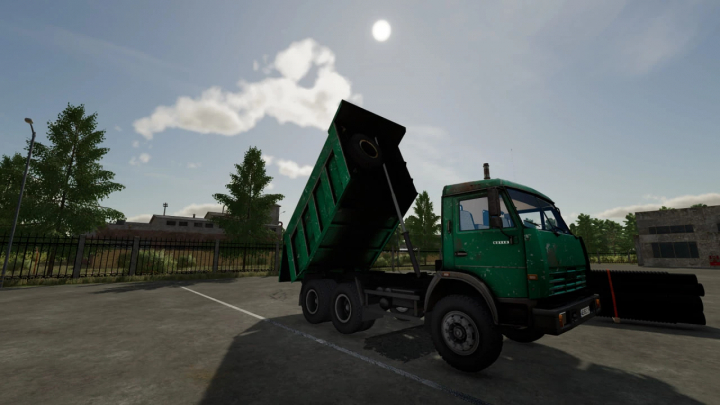 fs22-mods,  Farming Simulator 22 mod featuring a green KamAZ 65115 truck with a tipping bed in a parking lot.
