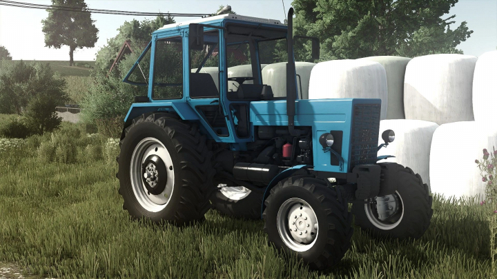 fs25-mods, Farming Simulator 25 mod: Blue tractor with large rear tires on a grassy field, part of FS25 mods.