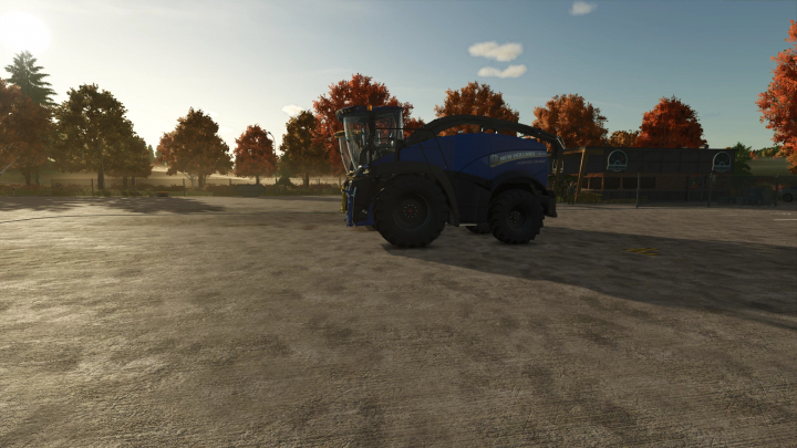 fs25-mods, Farming Simulator 25 mod: New Holland FR780 forage harvester in a farmyard during autumn with trees and blue sky.