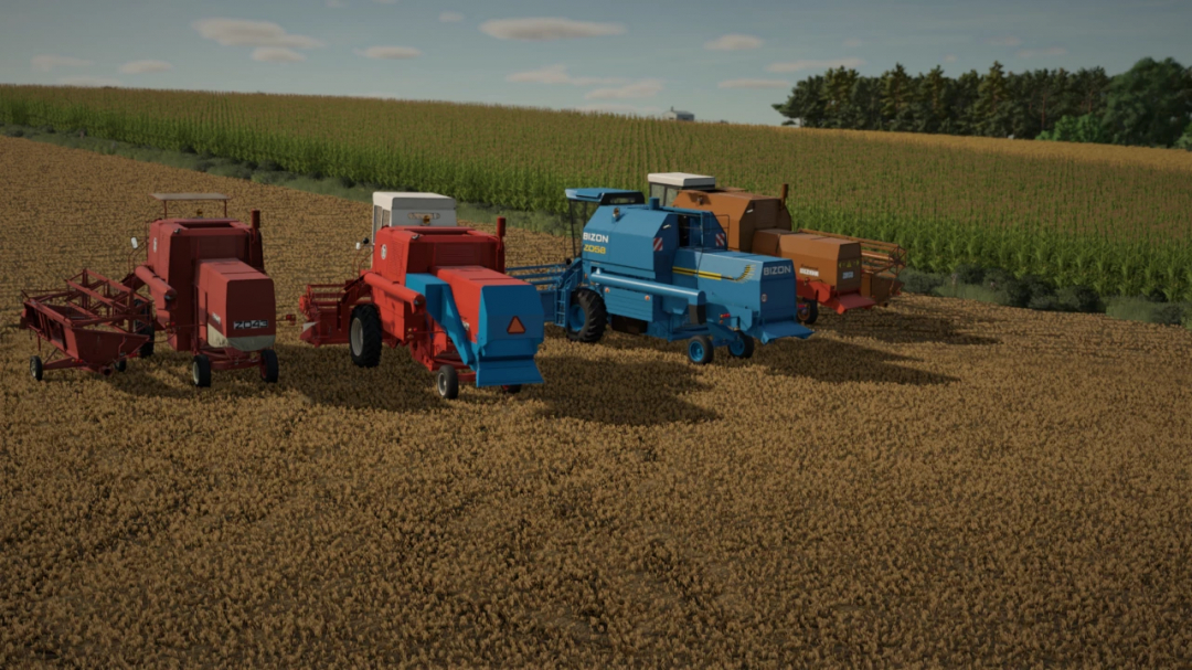 Farming Simulator 25 mods: collection of blue and red Bizon harvesting equipment on a farmland with crops.