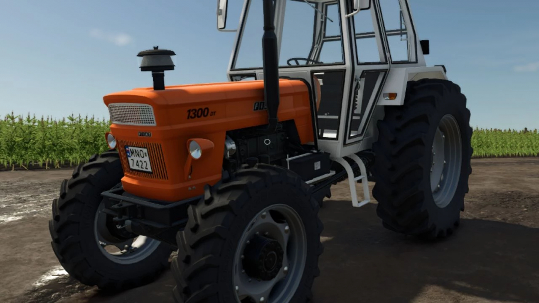 Farming Simulator 25 mod: Fiat 1300 DT tractor with orange paint, detailed interior, and large black tires on farmland.