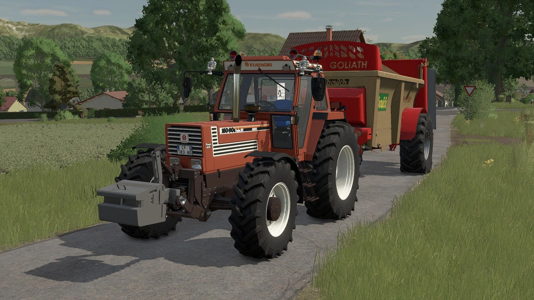 Farming Simulator 25 mod: Fiat DT Edit v1.0.0.0 tractor with attached implement on a rural road.