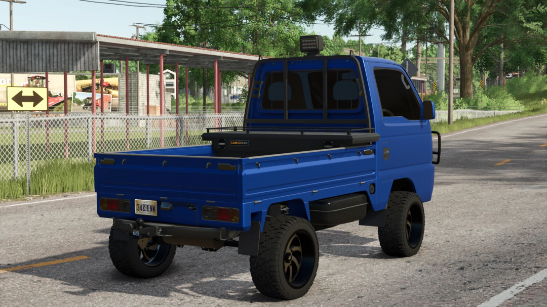 Blue compact pickup truck mod in Farming Simulator 25, featuring a flatbed with a mounted tool storage box, part of FS25 mods.