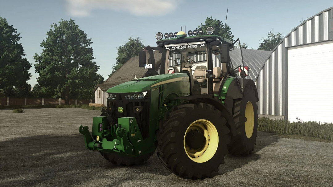 Farming Simulator 25 mod: John Deere 8R Series Edit v1.2.0.0 tractor, detailed and realistic, on farmyard with barn and trees.