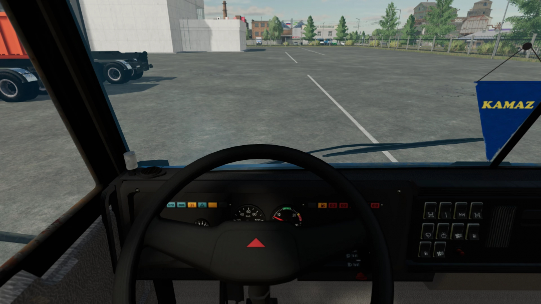 Inside view of a KamAZ truck from Farming Simulator 22, showing the dashboard and parking lot outdoors with KamAZ banner visible.