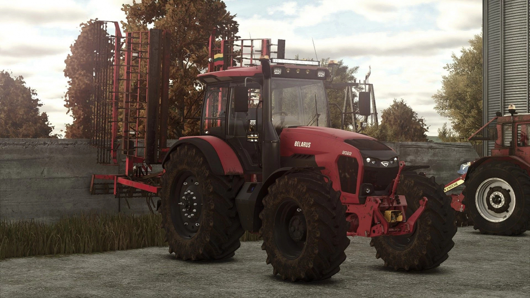 Farming Simulator 25 mod: Belarus MTZ 2022 tractor with mud-covered tires, parked on a farm environment.