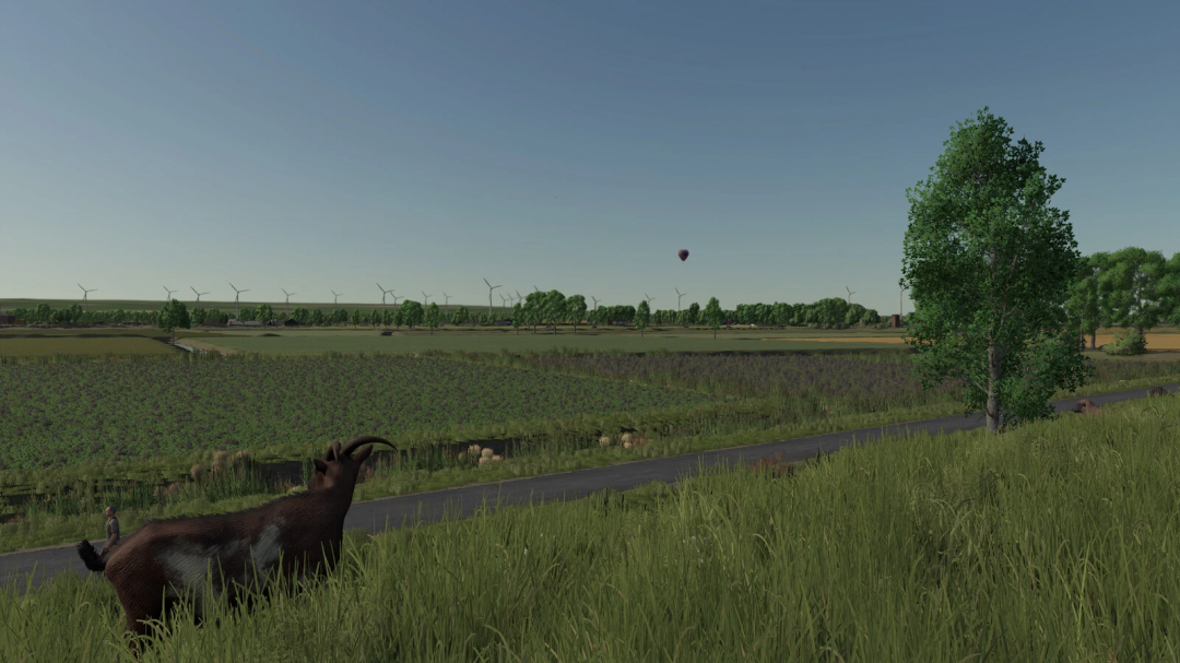 Farming Simulator 25 mod scene with wind turbines, trees, a person, a goat, and a hot air balloon in a rural landscape.