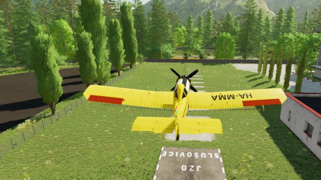 Farming Simulator 25 mod showcasing the yellow PZL-Mielec M18 Dromader airplane on a grass field with trees.
