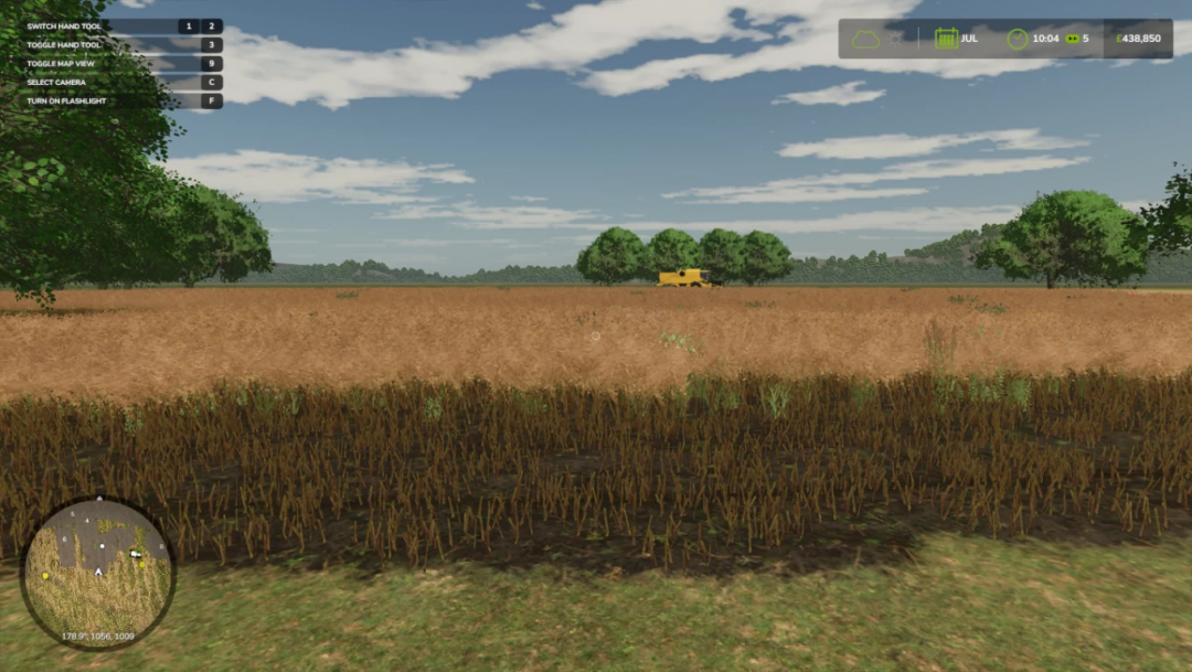 Farming Simulator 25 mod screenshot showing a wheat field, trees, and a vehicle in the distance, part of the Suffolk demo v1.0.0.0 for FS25 mods.