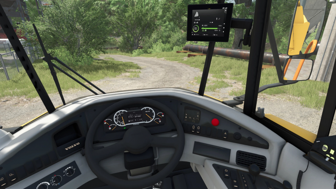 Inside view of a Volvo A25G wheel loader in Farming Simulator 25, showing the dashboard, steering wheel, and digital screens.