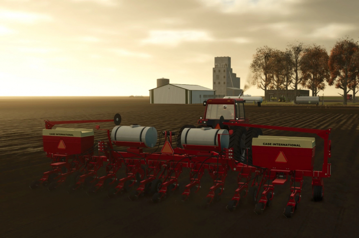 fs25-mods,  Farming Simulator 25 mod: Case IH Cyclo950 planter attached to a tractor on a farm with silos and barns in the background.