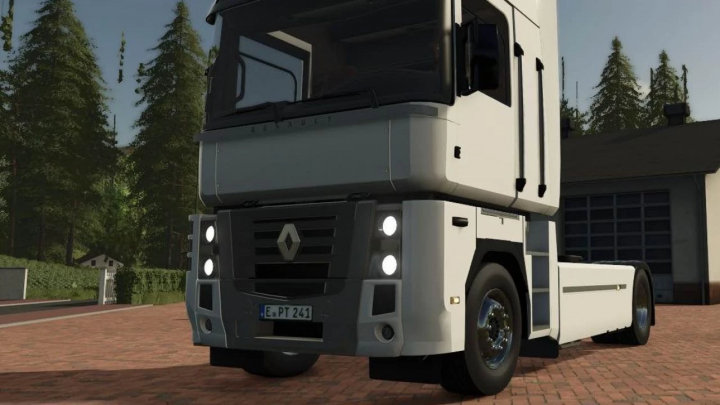 fs25-mods,  FS25 mod: Renault Magnum v1.0.0.0 truck in Farming Simulator 25, parked on a brick driveway, with trees in the background.