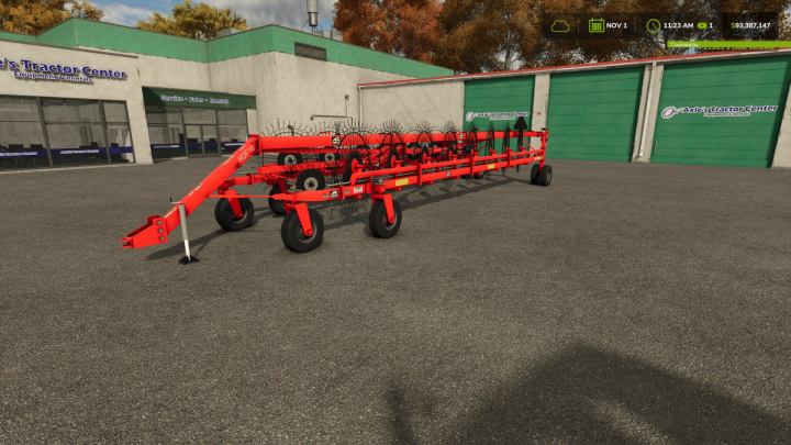 fs25-mods,  Farming Simulator 25 mod: Rhino Rake v1.0.0.0, a red agricultural rake for field work, showcased outside an equipment center in FS25.