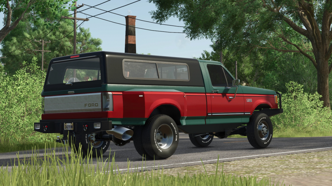 FS25 mod: 1990 Ford F250 truck with a two-tone green and red paint job, parked on a rural road surrounded by trees in Farming Simulator 25.