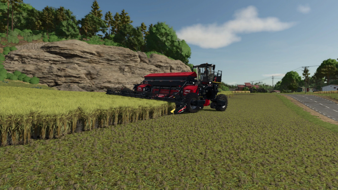 Farming Simulator 25 mod showing a modern rice harvester working in a field with trees and rocks in the background.