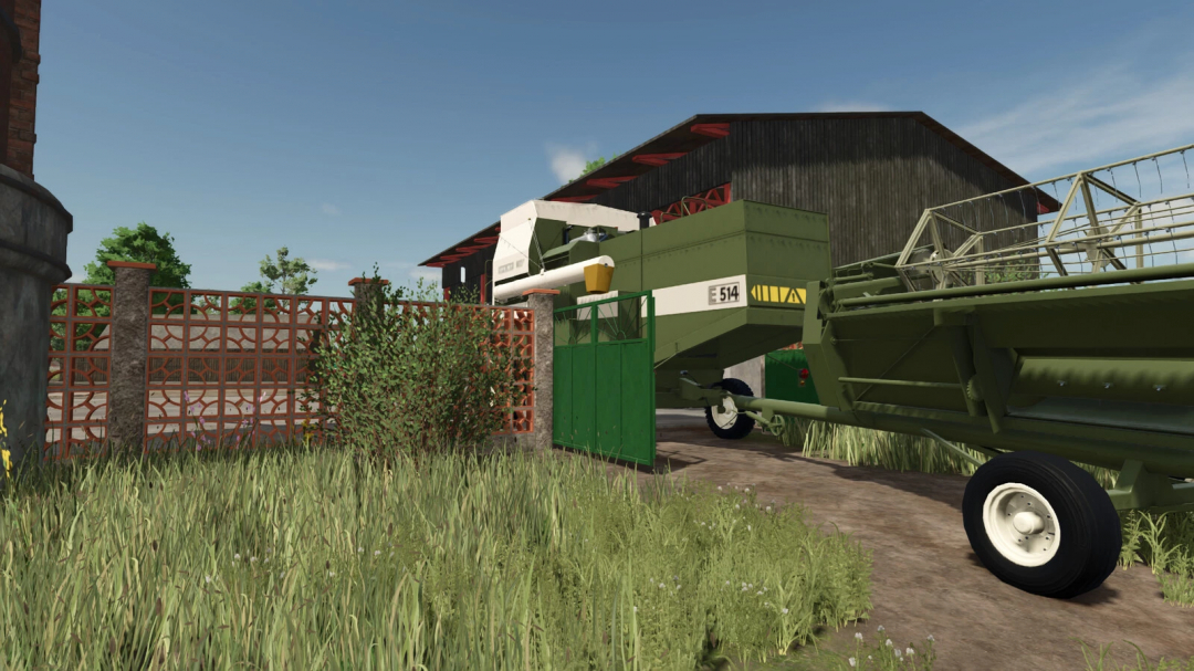 Farmer's field with a large green combine harvester, old brick fence, and a greenhouse in Farming Simulator 25 mods.
