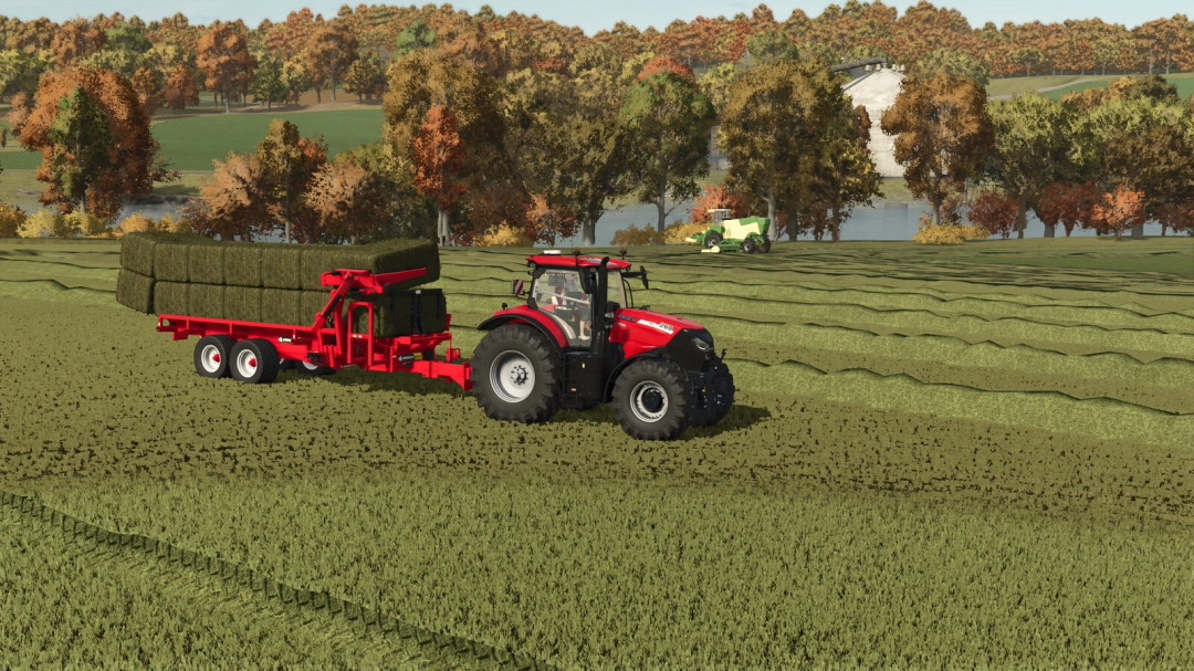 Farming Simulator 25 mod: Red tractor with hay trailer loaded with hay bales, working in a scenic autumn field.