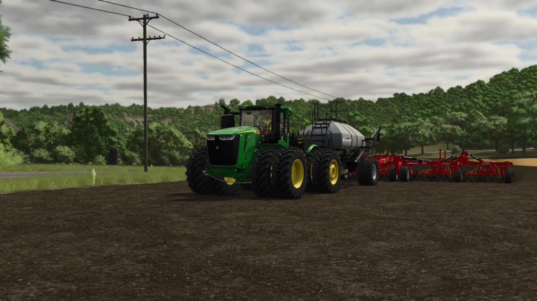Farming Simulator 25 mods: Green John Deere tractor with a red plow attachment, working on a farm field during cloudy weather.