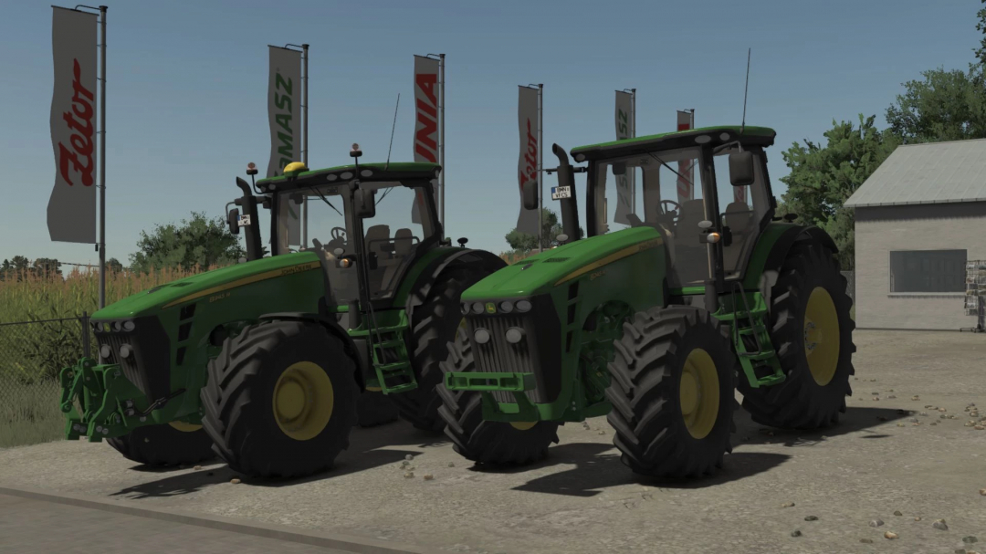Two John Deere 8R tractors from Farming Simulator 25 mods at a dealership with flags in the background.