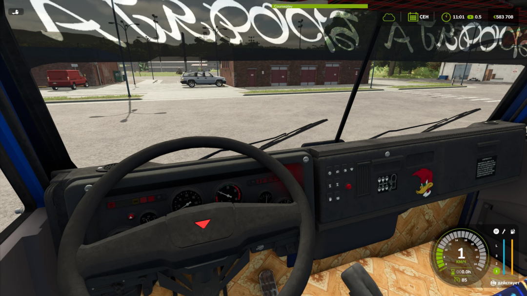 Inside view of a truck's cockpit in Farming Simulator 25, showing the dashboard, steering wheel, and a cartoon chicken sticker on the dashboard.