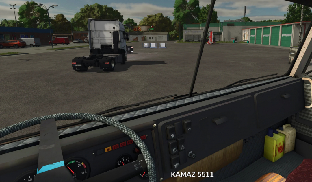 Interior view of a Farming Simulator 25 mod featuring a KamAZ 5511 truck outside in a parking lot, showcasing the detailed truck dashboard.