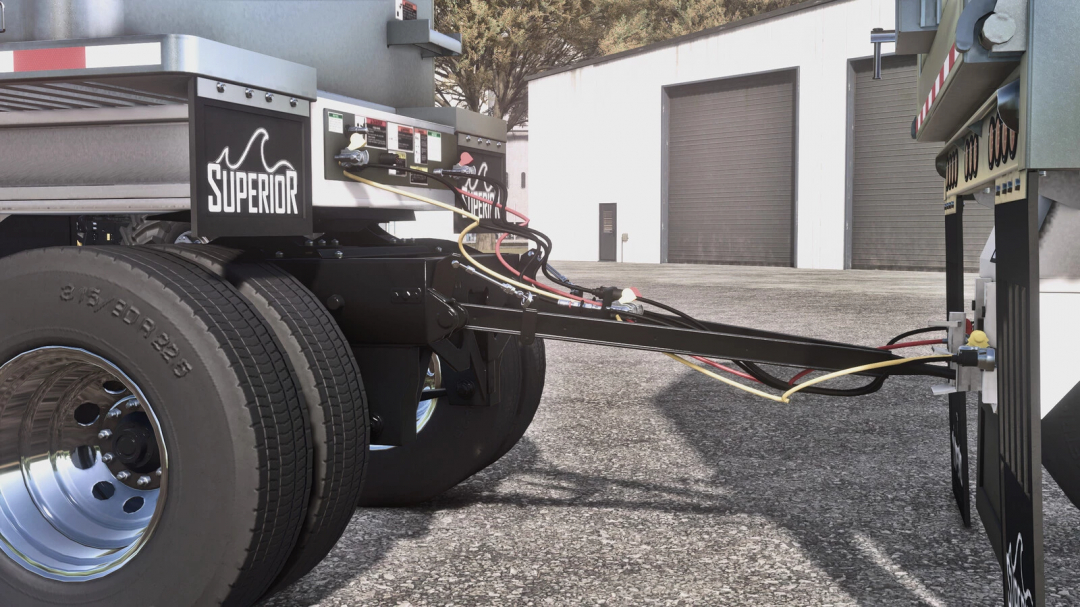 Farming Simulator 25 mod image of the Lizard Superior End Dump Trailer Pack v1.0.0.0 with detailed hoses and wheels, parked outside a storage unit.