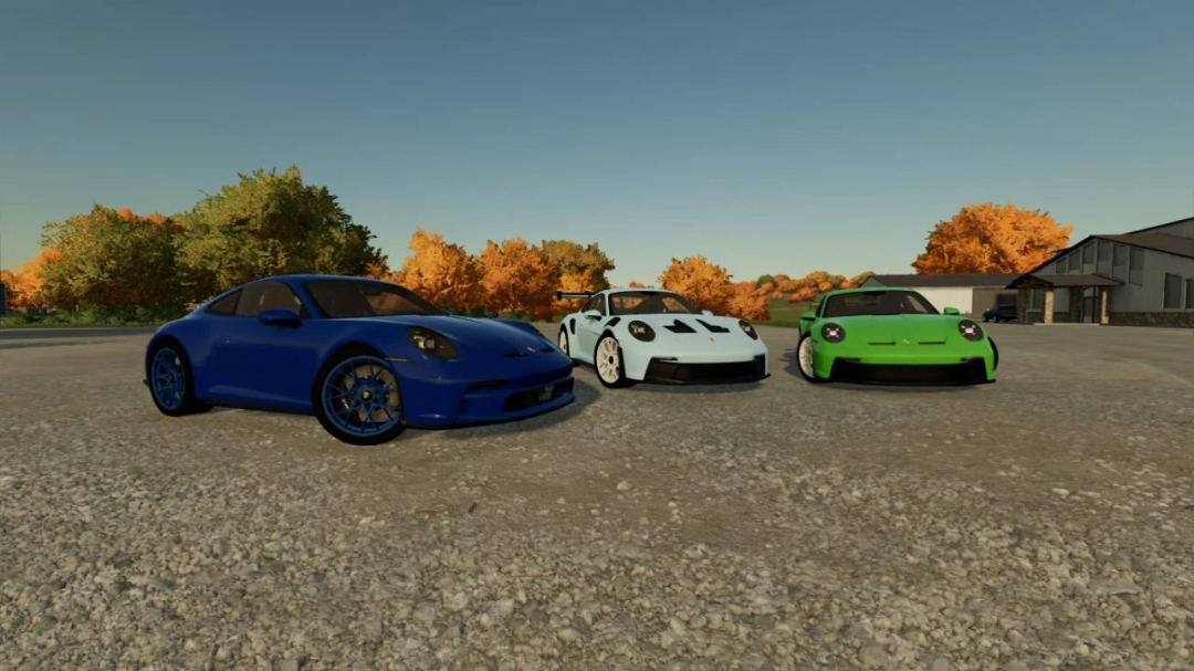Three custom Porsche sports cars from FS22 mods, including a blue, white, and green Porsche GT3, displayed outdoors in Farming Simulator 22.