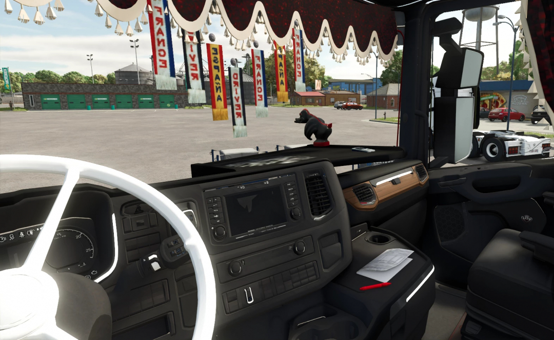Interior of a Farming Simulator 25 truck mod with dashboard, steering wheel, and decorations visible, showcasing FS25 mods.