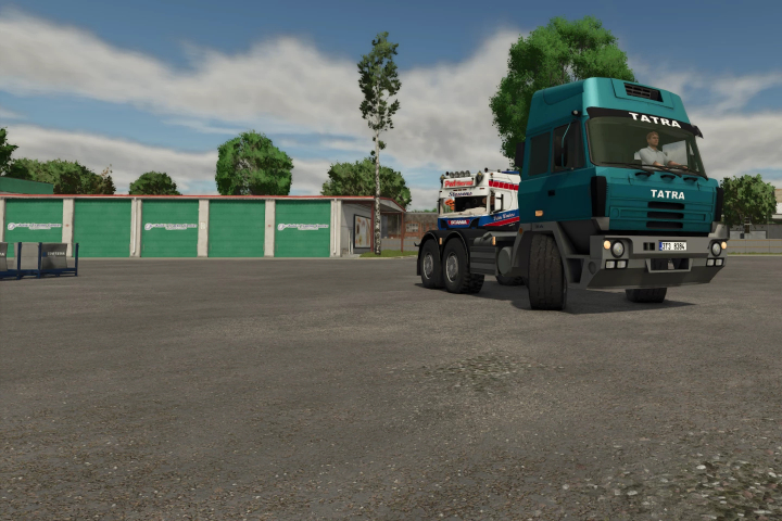 fs25-mods,  Farming Simulator 25 mod featuring a Tatra 815 truck in a parking area, with trees and a building in the background.