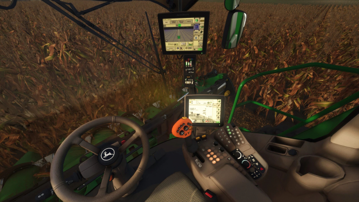 fs25-mods, Inside the cab of a John Deere S600 Series tractor in Farming Simulator 25, showing digital screens and controls amid a cornfield.