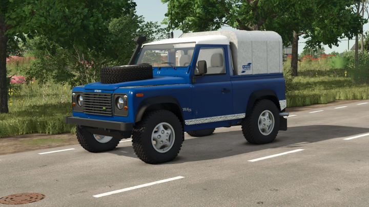 fs25-mods, Farming Simulator 25 mod: Land Rover Defender v1.0.0.0 in blue with spare tire on the hood, parked on the road surrounded by trees.