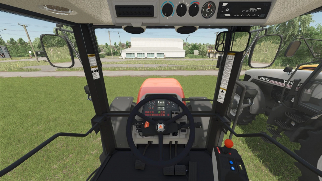 Interior view of a tractor from Farming Simulator 25, showcasing the dashboard, steering wheel, and controls for the AGCO Large Frames mod.