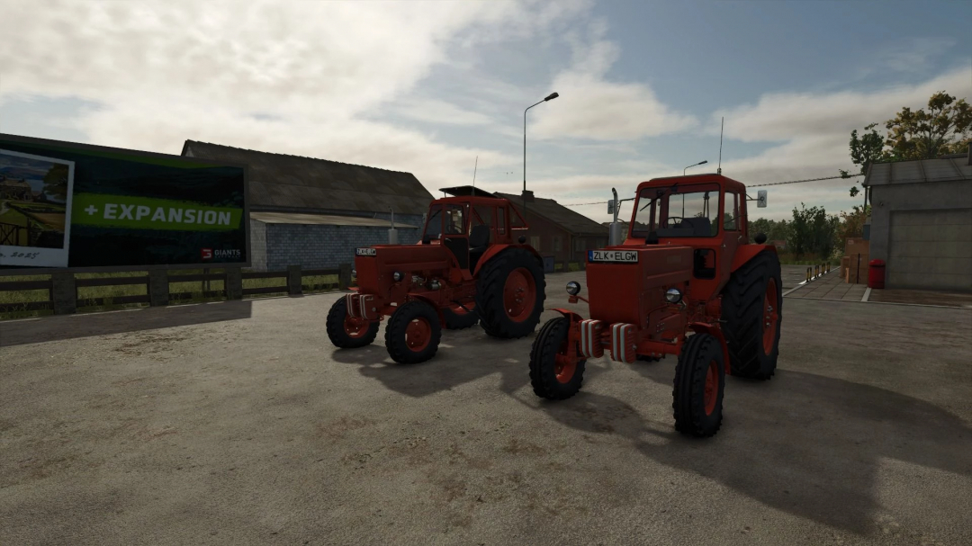 Two red tractors parked outdoors in Farming Simulator 25, showcasing FS25 mods, Belarus MTZ 80 v1.3.0.0.