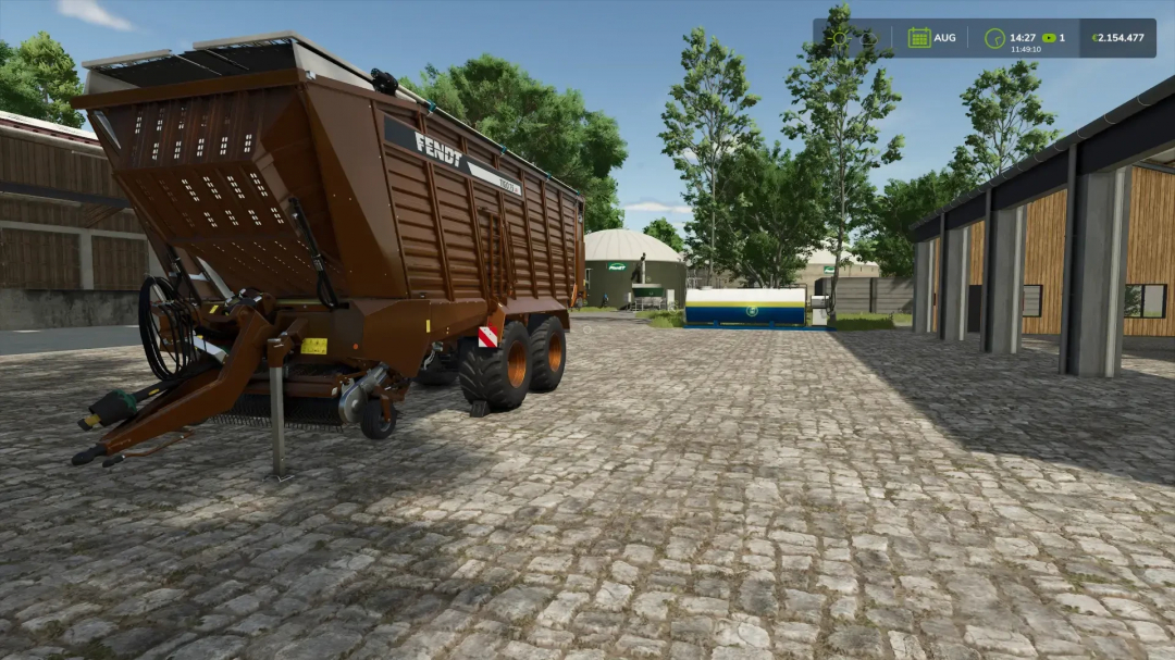 Fendt Tigo75VR v1.0.0.5 mod in Farming Simulator 25, showcasing a brown forage wagon on a farm yard with trees and equipment in the background.