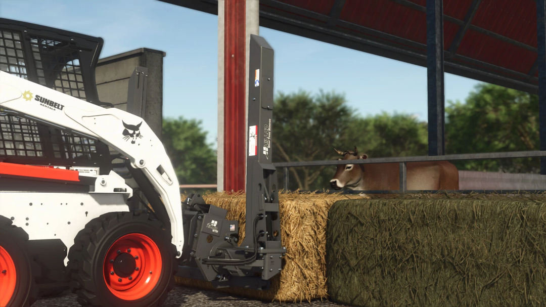 Farming Simulator 25 mod: Hillco Wrap Twine Remover attachment moving hay bales in a barn with a skid steer loader.
