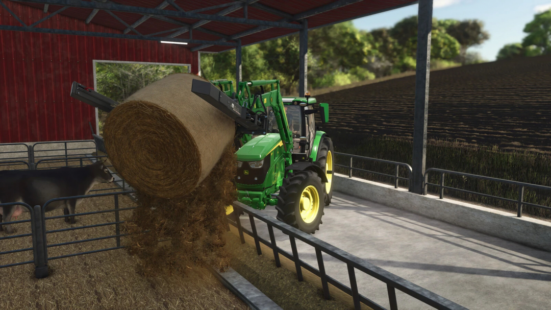 Farming Simulator 25 mod: John Deere tractor handling a large hay bale in a barn setting with cows nearby.