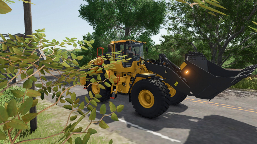 Farming Simulator 25 mod: yellow Volvo wheel loader with a black bucket attachment, clearing tree branches on a rural road.