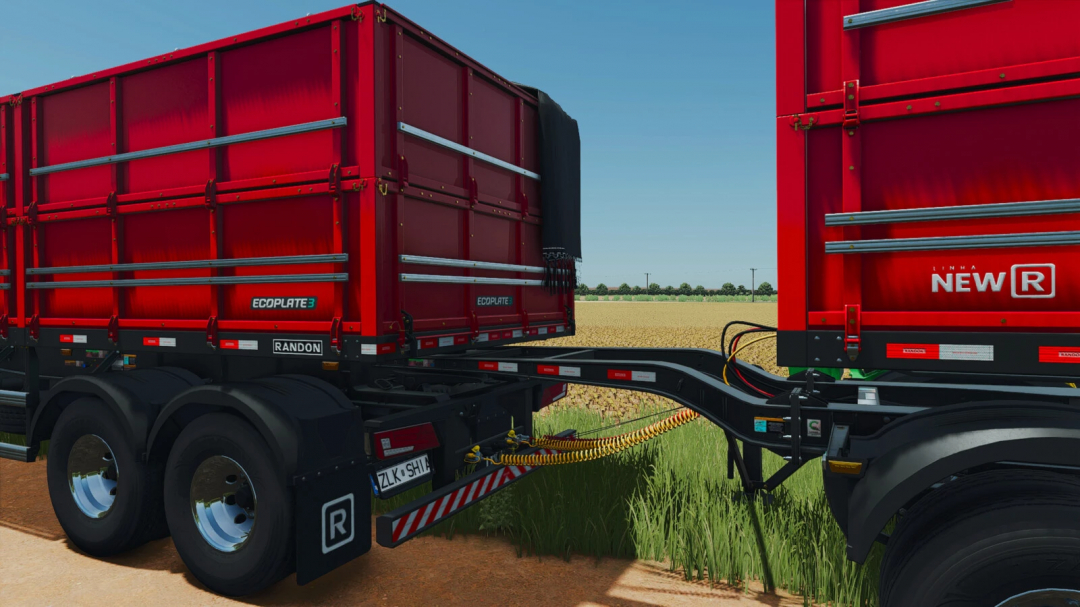 Farming Simulator 25 mod: Randon Rodotrem Bulk Carrier v1.0.0.0 in a field with red containers for agricultural transport.
