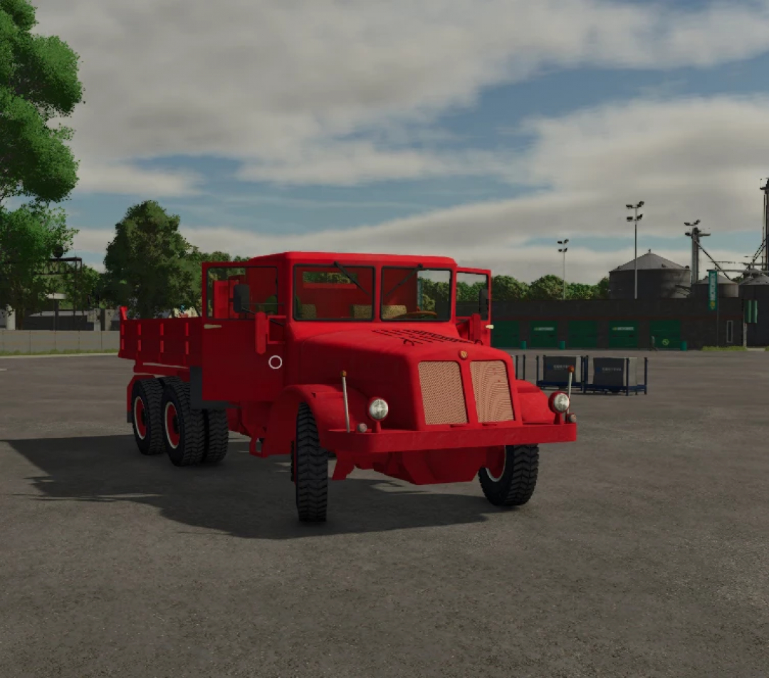 Red TATRA T111 mod truck from Farming Simulator 25, parked in an open area with trees and equipment in the background.