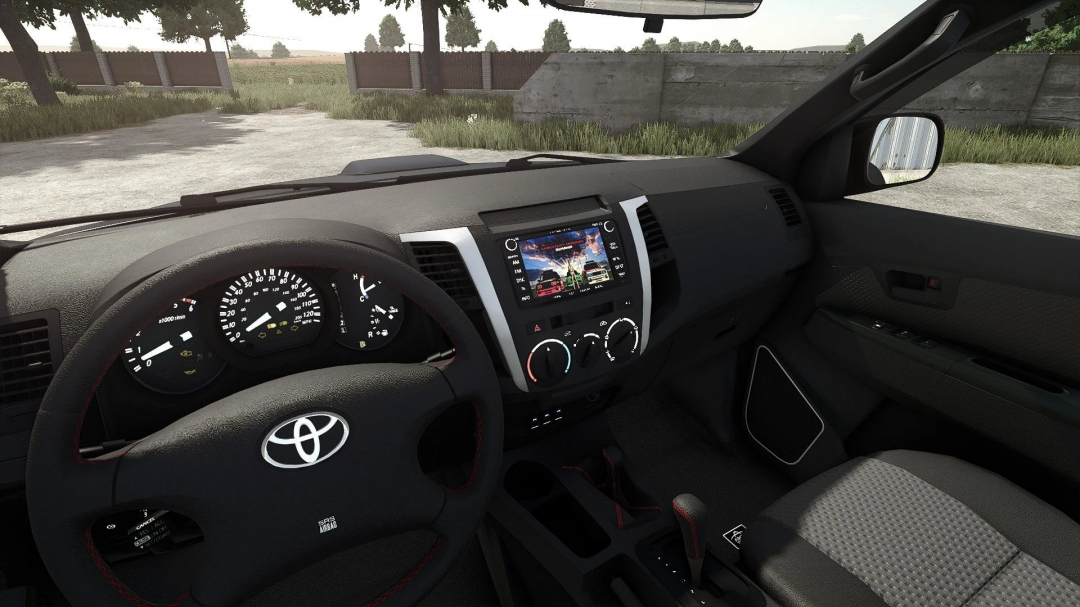 Interior of a Toyota Hilux Arctic mod in Farming Simulator 25, showcasing dashboard, steering wheel, and infotainment system.