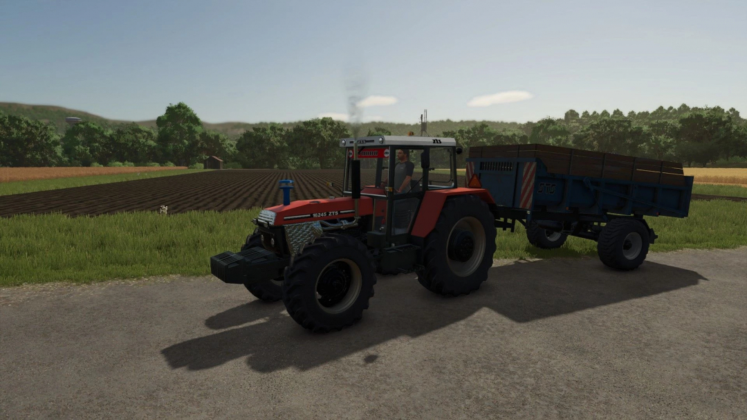 Farming Simulator 25 mod: Zetor ZTS 16245 Turbo tractor with attached trailer, on a rural farm landscape.