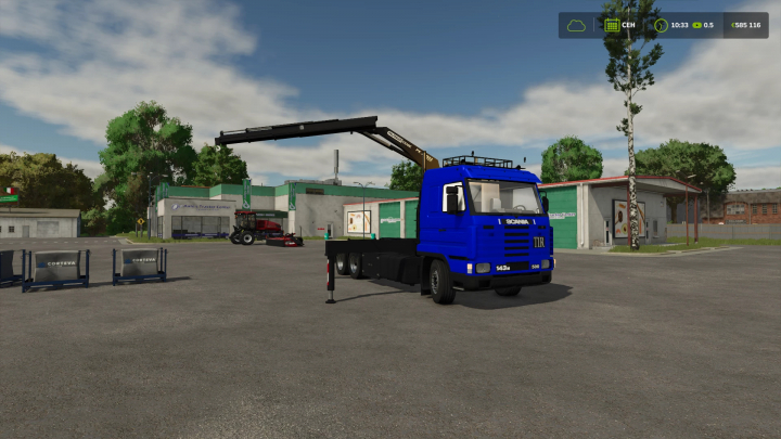 fs25-mods,  In Farming Simulator 25, a blue Scania 143 HKL tow truck with a crane is parked in a paved lot, surrounded by trees and farm buildings, representing FS25 mods.