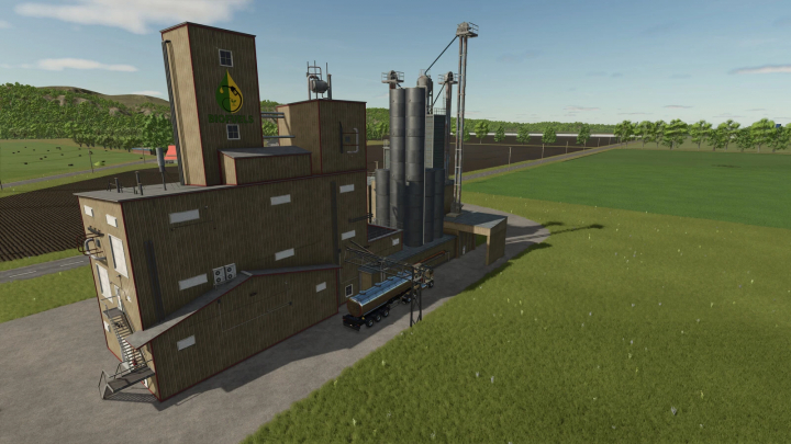 fs25-mods, Farm building with biofuels storage, part of FS25 mods, Farming Simulator 25 mods, in a green field under a blue sky.