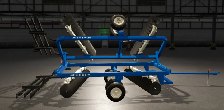 fs25-mods,  FS25 Ford Disc v1.0.0.0 mod for Farming Simulator 25, showing a blue farming implement with disc blades and rake attachments inside a warehouse.