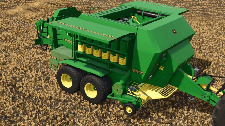 fs25-mods,  Farming Simulator 25 mod: John Deere baler in green with yellow wheels, placed on a harvested wheat field.